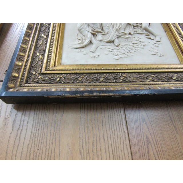 Striking vintage classical figural relief wall plaque featuring a dimensional mother-and-cherubs scene rendered in an...