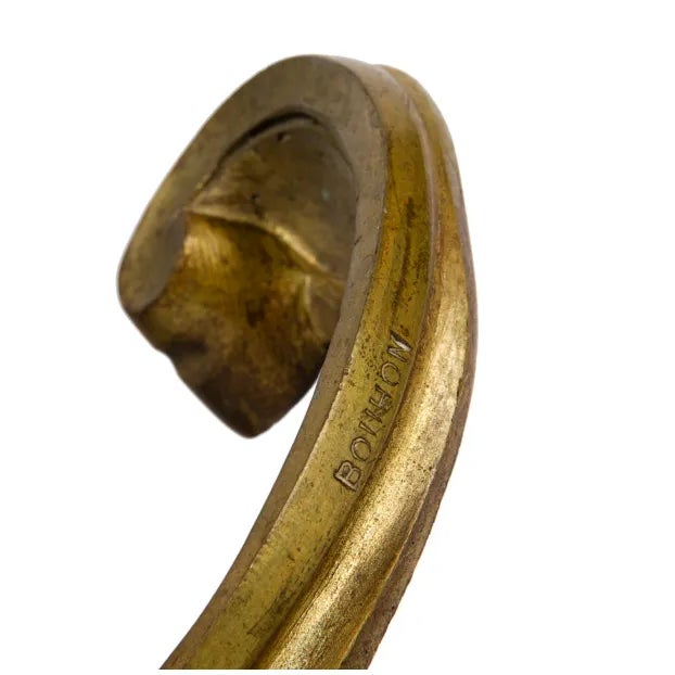 A pair of chenets signed by Bouhon in bronze of style Louis XV. Bouhon was a famous fireplace accessories maker in the...