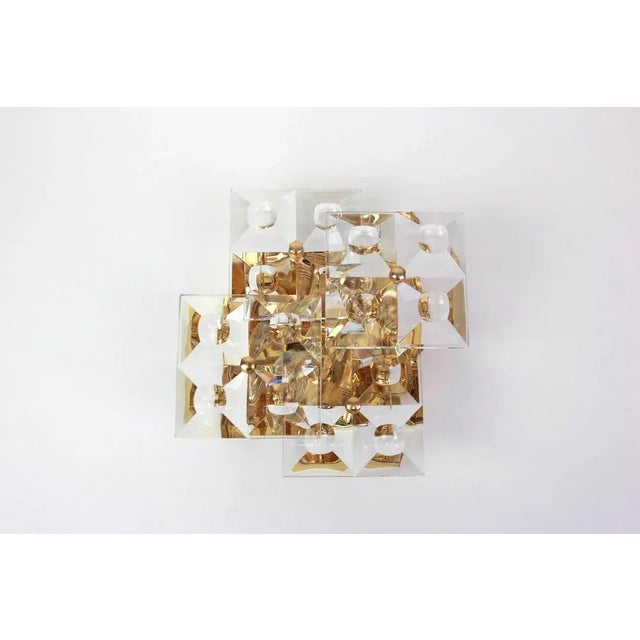 A stunning pair of golden sconces with crystal glasses, made by kinkeldey, germany, circa 1970-1979. It’s composed of...