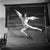 This dynamic black-and-white photograph, taken by klaus redenbacher in 1952, captures a male dancer mid-leap in a moment...