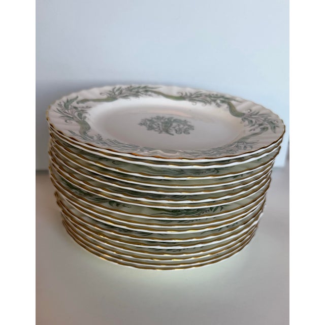 A handsome and rare set of sixteen Royal Worcester bone china dessert plates, retailed by the distinguished London firm...