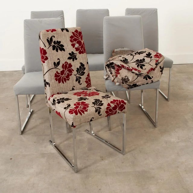 A set of six (6) Milo Baughman-inspired armless dining chairs from the late 20th century. Squared seats rest on chrome...