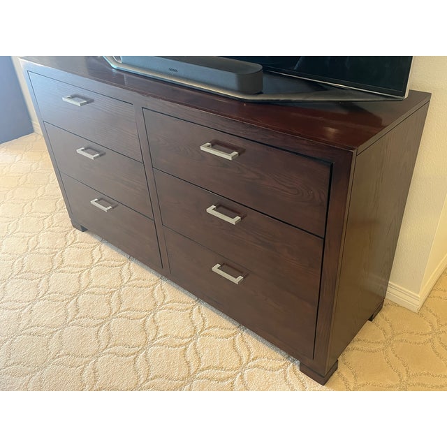 This substantial double dresser with matching mirror makes a striking statement in any bedroom. The dresser is finished in...