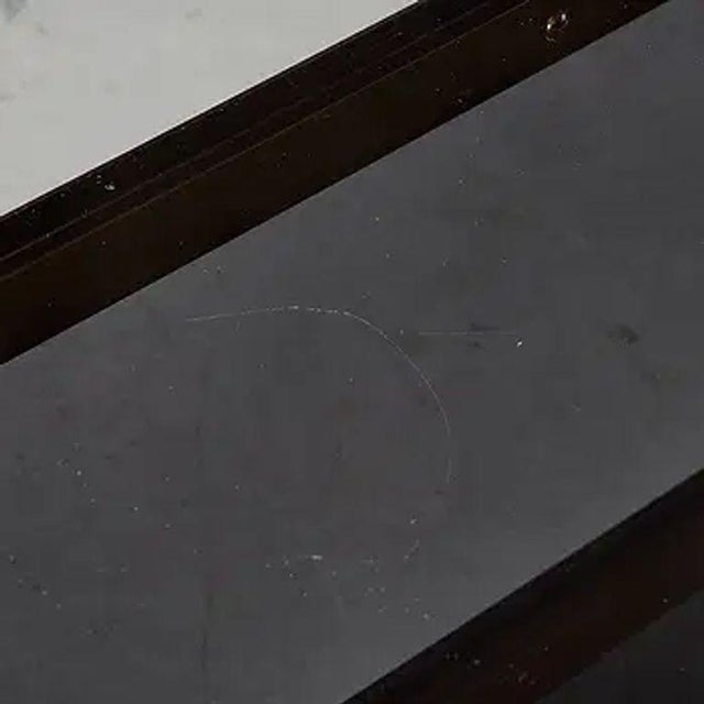 This signed Karl Springer steel and brass coffee table exudes mid-century modern style with its steel glass and brass base...