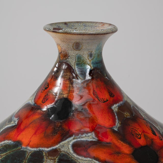 This charming 20th-century German ceramic pot with a lid is a delightful blend of functionality and artistic expression....