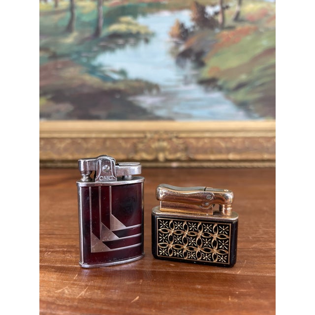 This set features two collectible vintage tabletop lighters, each with distinctive mid-century character and...