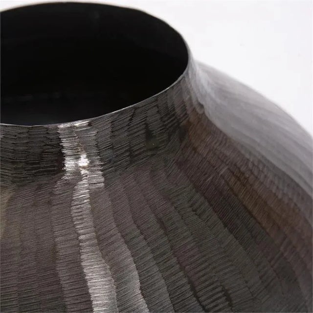 The Carbon Gray Round Chiseled Aluminum Vase This aluminum globe vase features a soft and fluid chiseled texture that will...
