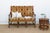 A settee this size, carved this deeply, doesn't come along in every shipment. Its arms scroll out in tight, ram's-horn...