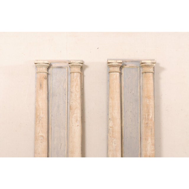 A pair of tall carved French wood columns from the 19th century. This antique pair of wooden architectural elements from...