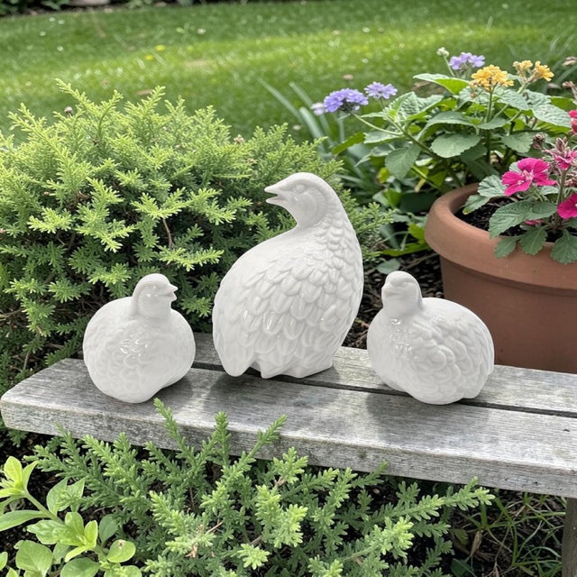 A mid-century set of three Japanese porcelain quail figurines, executed in a cohesive sculptural grouping with a high-...