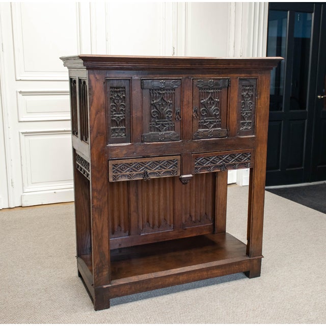 Striking 18th-century oak cabinet, executed in a rich Gothic Revival style with strong architectural presence. The piece...