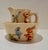 This antique Weller Pottery pitcher and bowl set features a storybook design of birds and rabbits in raised relief, hand-...