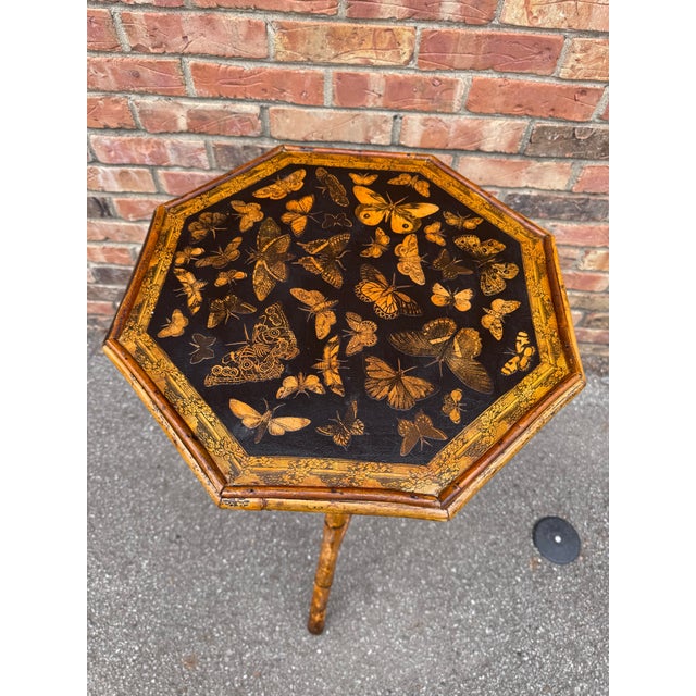 This 19th Century English Bamboo Side table features a delightful variety of butterflies decoupaged onto the top shelf....