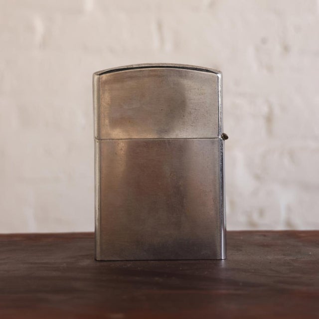 A distinctive 1960s Belgian Tin XL Lighter, featuring an oversized scale, clean architectural form, and softly aged metal...