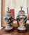 Striking pair of vintage Chinese Famille Noire-style porcelain table lamps featuring a rich black ground decorated with...