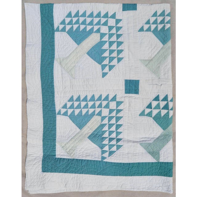 This summer-weight cotton quilt is in shades of green on an off-white ground. It was discovered at an estate in New...
