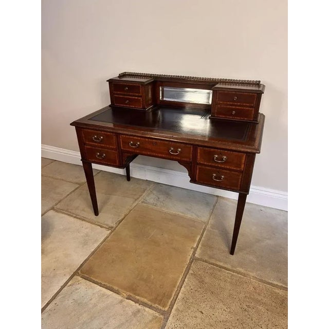 Antique Edwardian quality mahogany inlaid writing desk, having the original brass gilded gallery above a small bevelled...