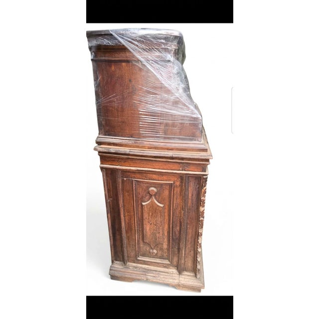 This 18th-century Italian walnut two-piece credenza is an exceptional example of Baroque-period craftsmanship,...