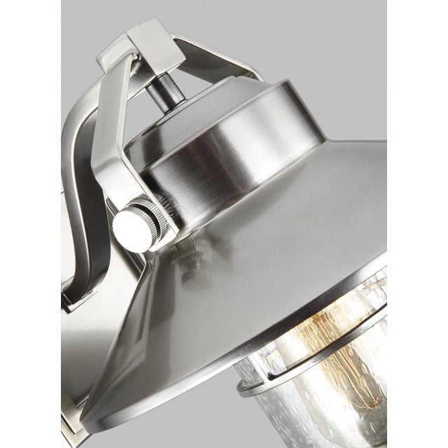 The Sean Lavin Boynton one-light outdoor pendant fixture in painted brushed steel creates a warm and inviting welcome...