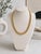 A striking vintage Italian Tubogas collar necklace crafted in rich 14 karat yellow gold, dating to circa 1975. This...