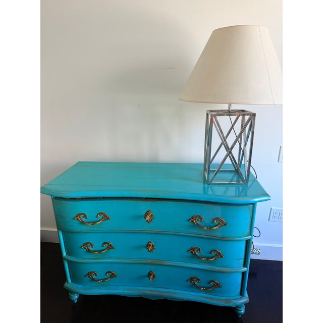 Elegant French Louis XIV-style chest of drawers featuring a beautifully curved front and three spacious drawers. Crafted...