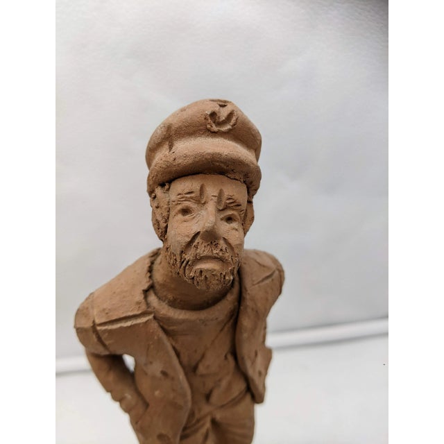 A rare find!! Charming Statue of a curious sailor handmade in terra cotta or clay. Signed only Jenni on the bottom....