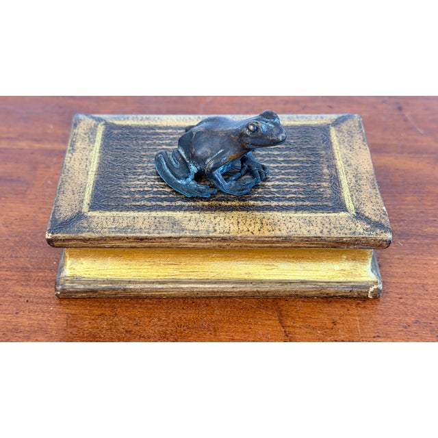 Charming bronze frog on a Romeo and Juliet faux book. Frogs represent different things in different cultures. In Japan,...
