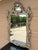 An exceptional late 20th century French Louis XV silvered giltwood mirror with richly carved Rococo detailing and a...