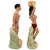 This pair of vintage mid-century ceramic figurines depicts a stylized Polynesian man and woman. Hand-painted with a glossy...