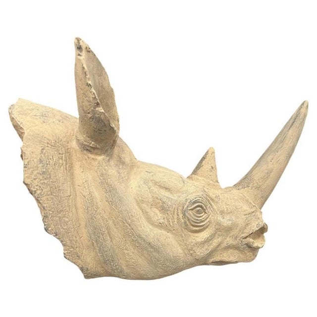 A striking and highly decorative rhinoceros head bust sculpture, realistically modelled and presented on a substantial...