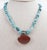 Contemporary sterling silver, turquoise nugget necklace with bezel set carnelian cabochon pendant. Marked 925 sterling...