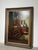 An evocative oil on canvas by Richard Leutenez depicting a warmly lit domestic interior centered around an elegant wooden...