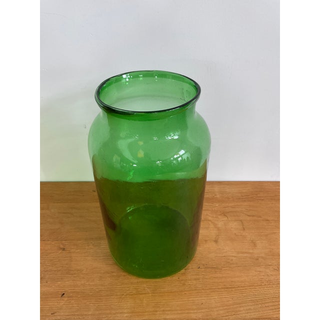 Add a layer of rustic elegance to your space with this stunning Large Green Glass Pickle Jar. This vintage piece features...