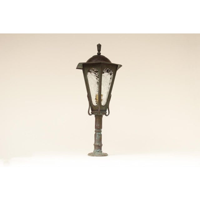 Handcrafted lantern made of cast and wrought copper. over decades, cast copper develops a dark brown to greenish patina...