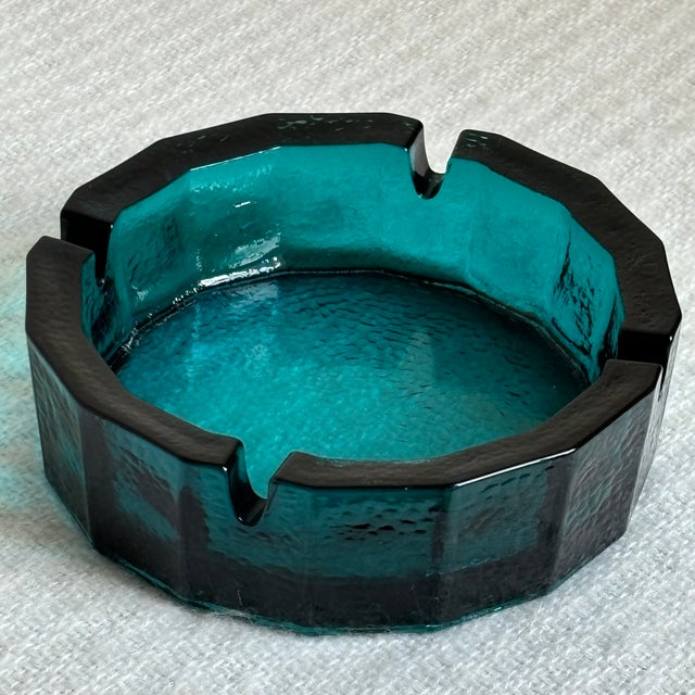 A gorgeous circa 1960 Mid-Century Modern pebbled glass ashtray in a rich teal. This is one of two identical ashtrays...