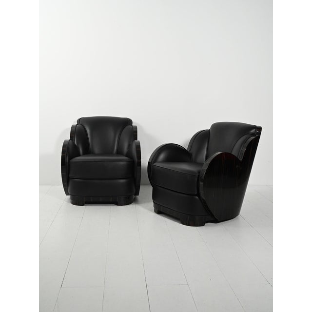 Two Scandinavian armchairs with fan-shaped backrests, black leather and Macassar ebony veneer, with a refined Art Deco...