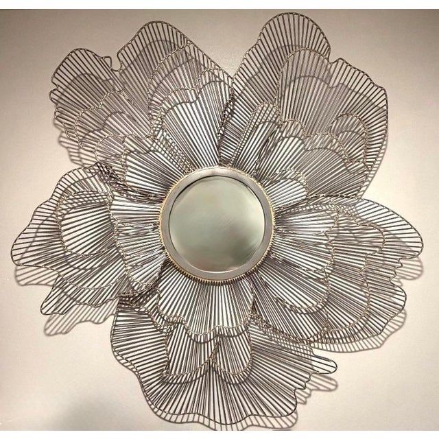 The sculptural Feyre Iron Poppy Mirror by Studio A Home for Global Views offers a whimsical, dimensional interpretation of...