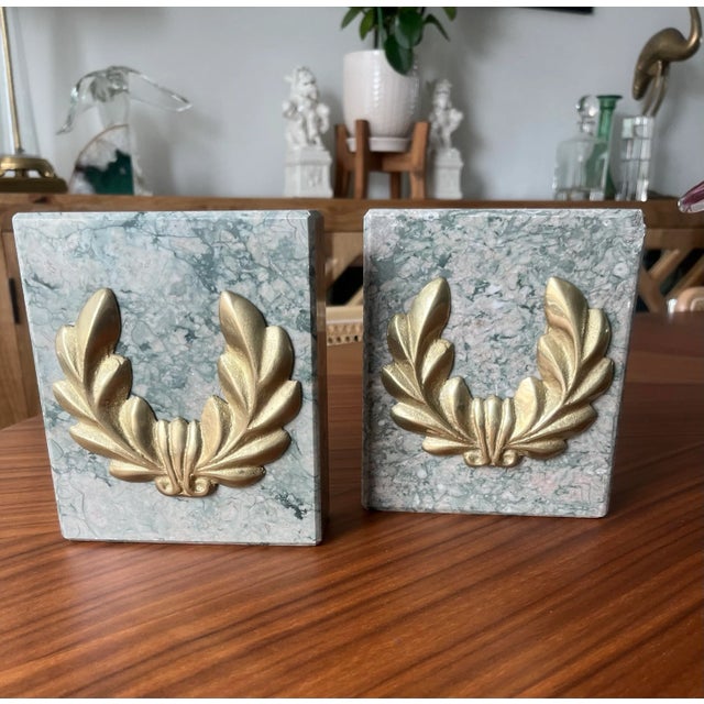 Gorgeous gilt bronze laurel wreaths on a beautiful green stone background. This pair is heavy in both weight and meaning.