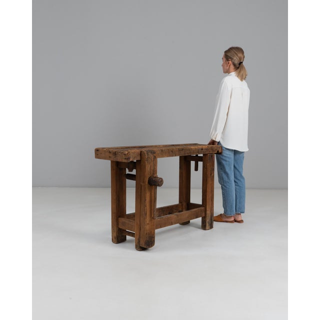 This 20th Century French wooden work table reflects the practical beauty of traditional artisan furniture. Built from...