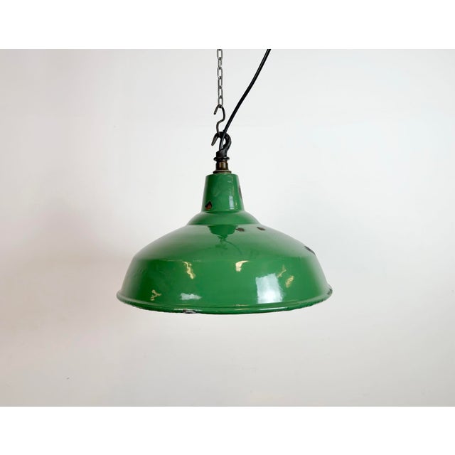 Industrial green enamel factory pendant light made in United Kingdom during the 1960s. White enamel inside the shade. Iron...