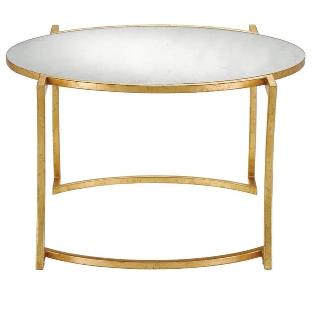 Stylish modern Currey & Co. Lenox Cocktail Table, gold leaf finished frame with a smart juxtaposition of curvy and...