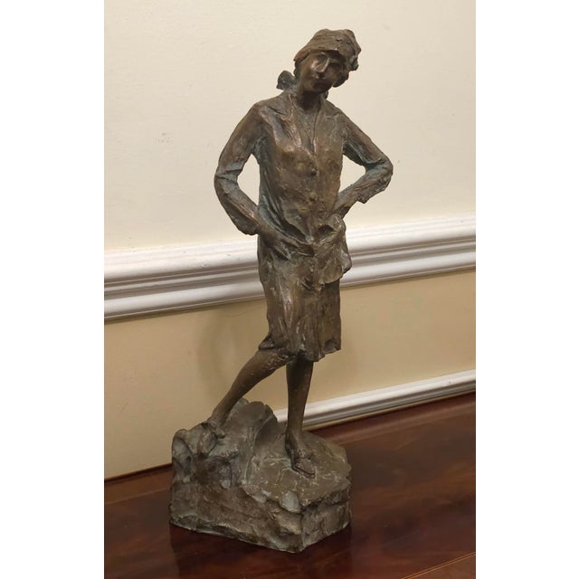 A brutalist bronze sculpture of well dressed standing woman in good vintage condition. Measures 6" in width, 6" in depth...