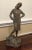 A brutalist bronze sculpture of well dressed standing woman in good vintage condition. Measures 6" in width, 6" in depth...