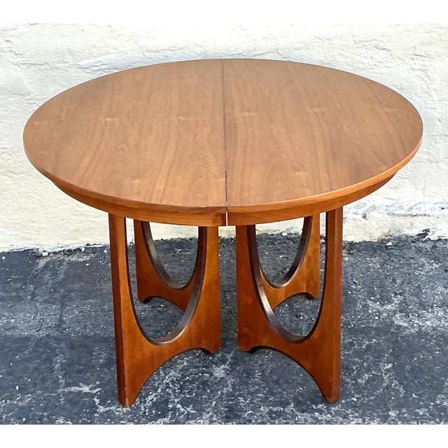 This striking vintage wood extendable dining table by Broyhill Brasilia is a quintessential masterpiece of mid-century...