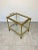 Serving bar cart in a brass structure with bamboo effect and glass shelves, the upper one removable and usable as a...