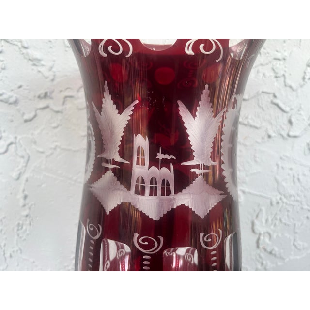 This striking Bohemian Egermann ruby cut-to-clear vase features classic 19th-century revival motifs, including stipple-...