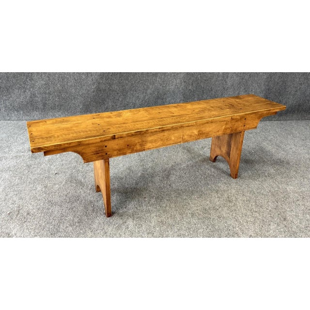 This vintage pegged maple bench features a solid plank top secured with visible wooden pegs, showcasing honest...