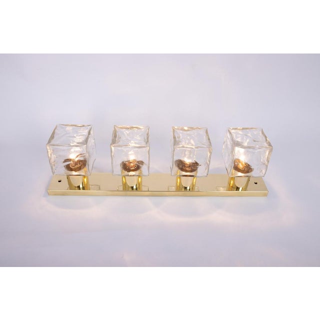 Set of two large murano ice glass wall lights by kalmar, austria, manufactured in the 1960s. The wall light is composed of...