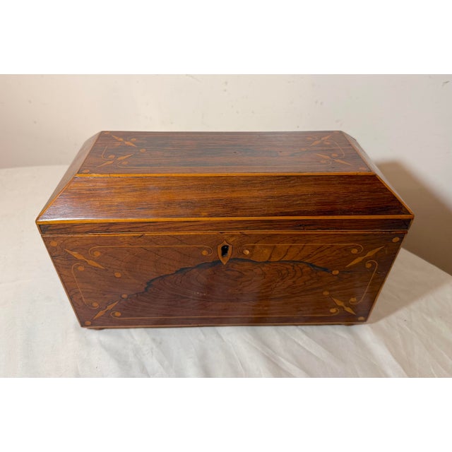 Crafted with meticulous attention to detail, this antique early 19th century antique English Regency sarcophagus-form tea...