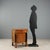 Empire walnut bedside table. The projecting drawer under the top is supported by turned and ebonized columns, resting on...